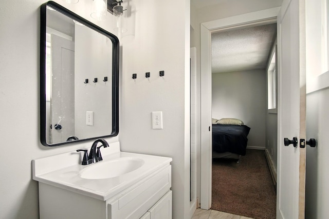 14018 E Valleyway Ave, Spokane, WA 99216 - bathroom featuring vanity, a textured ceiling, ensuite bathroom, and baseboards