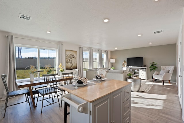 713 E L St, Deer Park, WA 99006 - kitchen with wood finished floors, a kitchen island, gray cabinets, recessed lighting, and light countertops