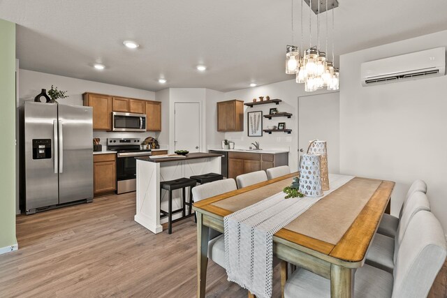 5111 E Frederick Ave, Spokane, WA 99217 - dining space featuring an AC wall unit, light wood-style floors, recessed lighting, and a chandelier
