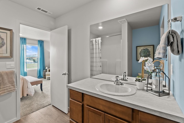 5111 E Frederick Ave, Spokane, WA 99217 - ensuite bathroom featuring wood finished floors, vanity, and a shower with curtain