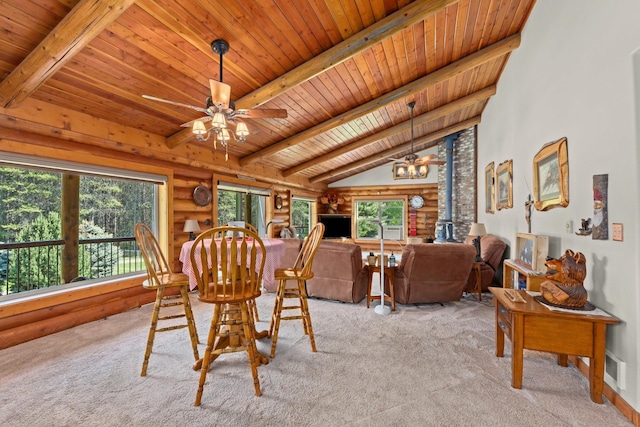 312 Pickett Rd, Ione, WA 99139 - carpeted dining space featuring wood ceiling, log walls, ceiling fan, and a wood stove