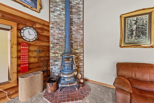 312 Pickett Rd, Ione, WA 99139 - living room with log walls, a wood stove, and carpet flooring