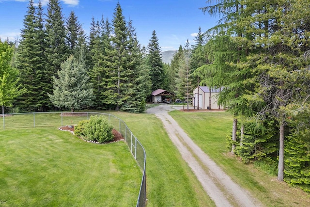312 Pickett Rd, Ione, WA 99139 - view of yard with driveway, an outbuilding, and a forest view