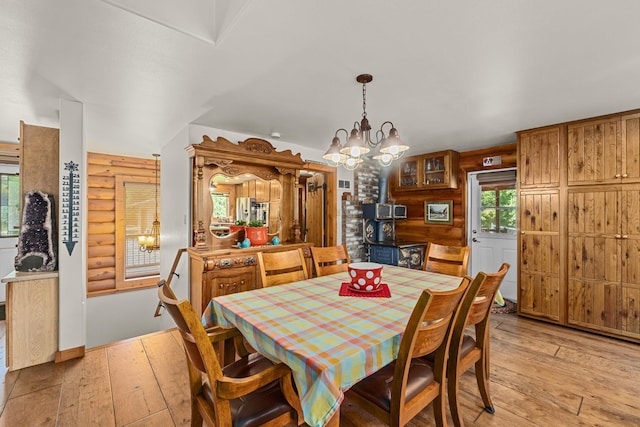 312 Pickett Rd, Ione, WA 99139 - dining area with light wood finished floors, a chandelier, and rustic walls