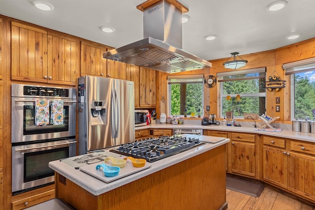 312 Pickett Rd, Ione, WA 99139 - kitchen featuring island range hood, appliances with stainless steel finishes, light countertops, brown cabinets, and recessed lighting