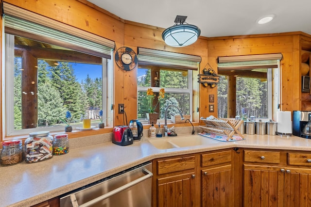 312 Pickett Rd, Ione, WA 99139 - kitchen featuring dishwasher, a sink, brown cabinets, and light countertops