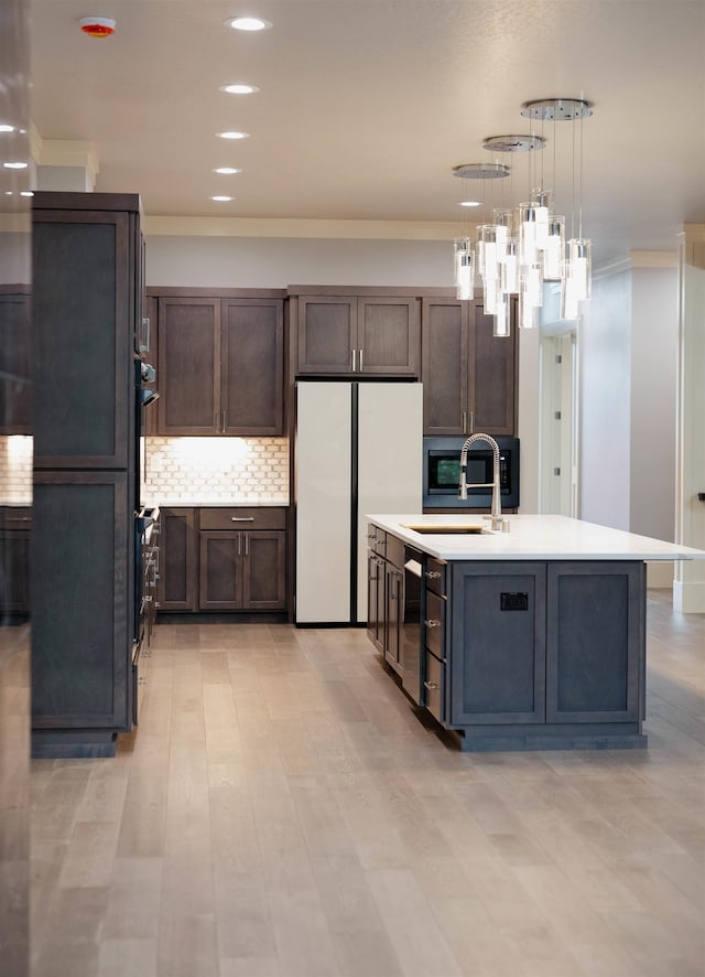 20168 E 11th Ln, Greenacres, WA 99016 - kitchen featuring freestanding refrigerator, a sink, light countertops, ornamental molding, and decorative backsplash