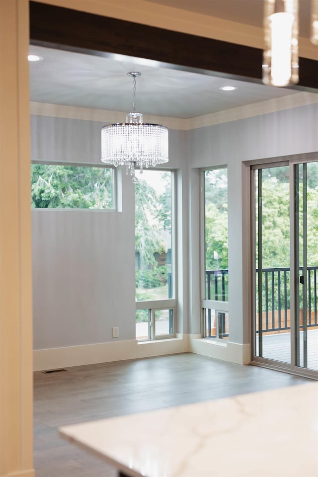 20168 E 11th Ln, Greenacres, WA 99016 - unfurnished room featuring wood finished floors, a chandelier, plenty of natural light, baseboards, and crown molding
