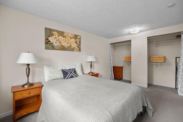 4238 E 24th Ave, Spokane, WA 99223 - bedroom featuring two closets, carpet floors, baseboards, and a textured ceiling