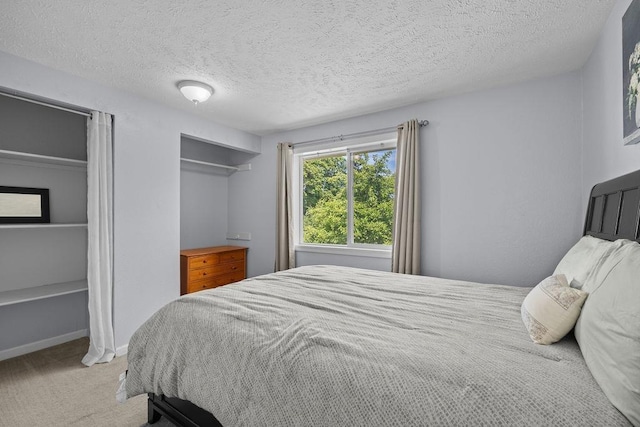 4238 E 24th Ave, Spokane, WA 99223 - carpeted bedroom with a textured ceiling and baseboards