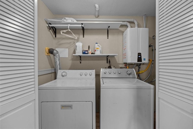 4238 E 24th Ave, Spokane, WA 99223 - washroom featuring tankless water heater, washer and dryer, and a textured ceiling