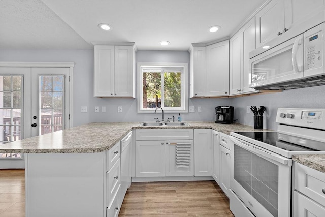 4238 E 24th Ave, Spokane, WA 99223 - kitchen with white appliances, a sink, a peninsula, light countertops, and white cabinets