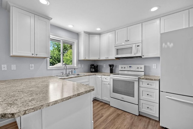 4238 E 24th Ave, Spokane, WA 99223 - kitchen with white appliances, a sink, light countertops, white cabinetry, and recessed lighting