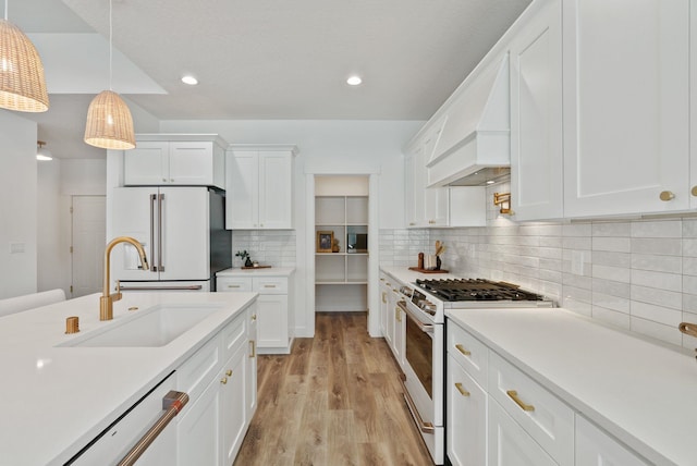 1217 E Granary Ct, Spokane, WA 99208 - kitchen with white appliances, a sink, white cabinets, light countertops, and hanging light fixtures