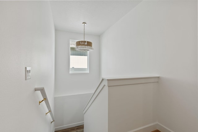 1217 E Granary Ct, Spokane, WA 99208 - staircase with a chandelier, baseboards, wood finished floors, and a textured ceiling