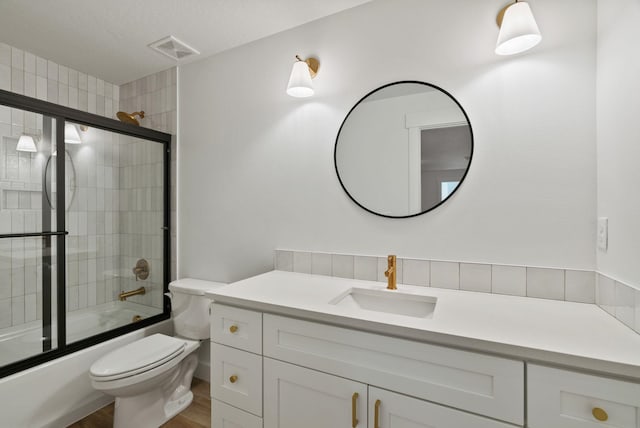 1217 E Granary Ct, Spokane, WA 99208 - full bath with vanity, toilet, combined bath / shower with glass door, and wood finished floors