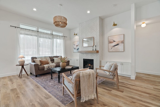 1217 E Granary Ct, Spokane, WA 99208 - living room featuring a fireplace, recessed lighting, light wood-style flooring, and baseboards