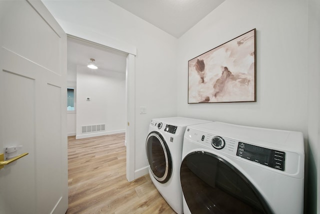 1217 E Granary Ct, Spokane, WA 99208 - laundry area with independent washer and dryer, light wood-type flooring, and baseboards