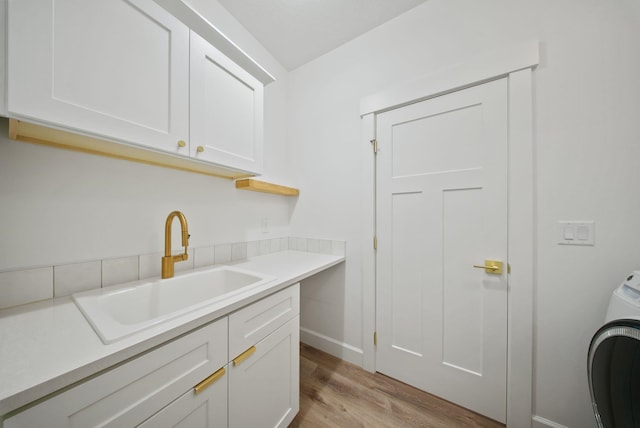 1217 E Granary Ct, Spokane, WA 99208 - laundry area with cabinet space, washer / clothes dryer, light wood finished floors, and baseboards