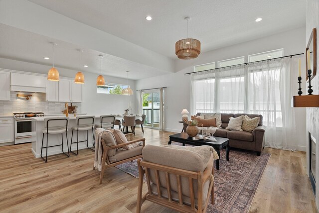 1217 E Granary Ct, Spokane, WA 99208 - living area with light wood-type flooring, recessed lighting, and baseboards