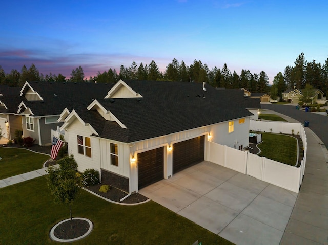 1217 E Granary Ct, Spokane, WA 99208 - view of front of house featuring an attached garage, concrete driveway, a shingled roof, and board and batten siding