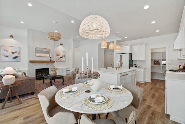 1217 E Granary Ct, Spokane, WA 99208 - dining space featuring recessed lighting, light wood finished floors, and a tiled fireplace