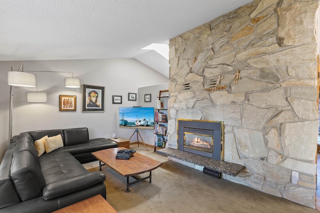 3014 S Perry St Unit 3014, Spokane, WA 99203 - carpeted living room featuring a textured ceiling, vaulted ceiling, a fireplace, and a skylight