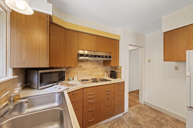 904 E 40th Ave, Spokane, WA 99203 - kitchen with white appliances, extractor fan, a sink, and brown cabinetry