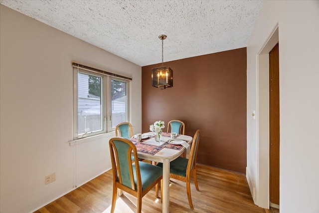 904 E 40th Ave, Spokane, WA 99203 - dining space featuring a chandelier, wood finished floors, and a textured ceiling