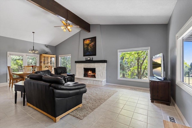 6913 S Ben Burr Rd, Spokane, WA 99223 - living area featuring beam ceiling, light tile patterned floors, a fireplace, a ceiling fan, and high vaulted ceiling