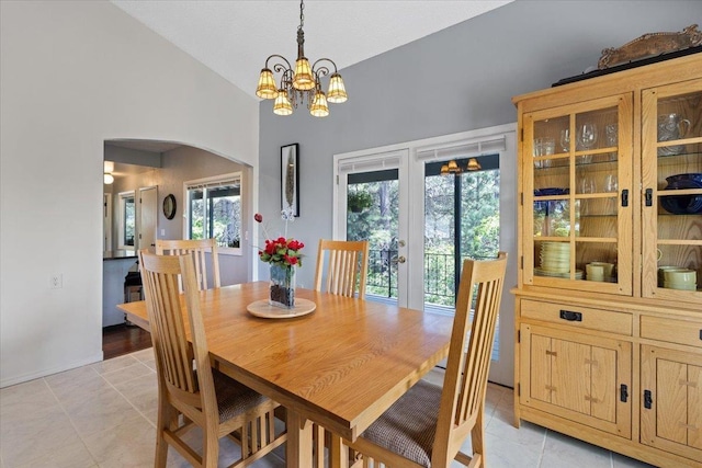 6913 S Ben Burr Rd, Spokane, WA 99223 - dining space with arched walkways, light tile patterned flooring, a chandelier, and high vaulted ceiling