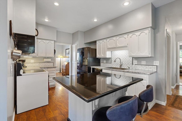 6913 S Ben Burr Rd, Spokane, WA 99223 - kitchen with range, freestanding refrigerator, white cabinetry, dark wood-style flooring, and recessed lighting