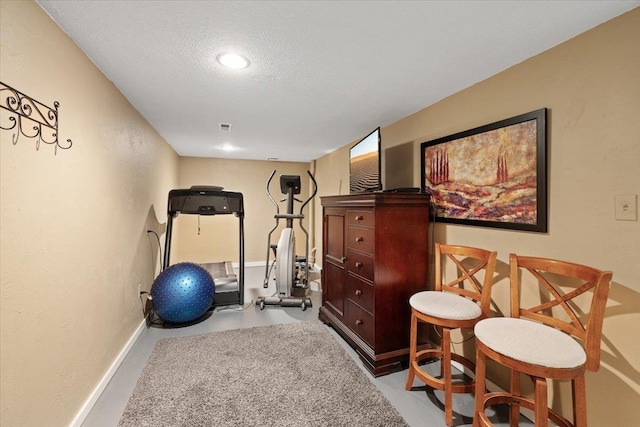6913 S Ben Burr Rd, Spokane, WA 99223 - workout room with a textured ceiling and baseboards
