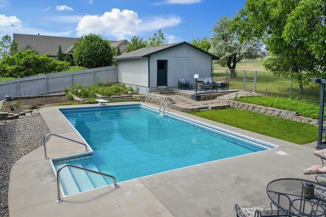 6913 S Ben Burr Rd, Spokane, WA 99223 - view of swimming pool with an outdoor structure, a patio, and a fenced backyard