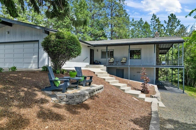 6913 S Ben Burr Rd, Spokane, WA 99223 - view of front of home featuring covered porch, a garage, and stairs