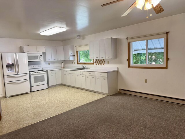 216 NW Cole Ave, Wilbur, WA 99185 - kitchen with white appliances, a sink, a baseboard radiator, light countertops, and ceiling fan