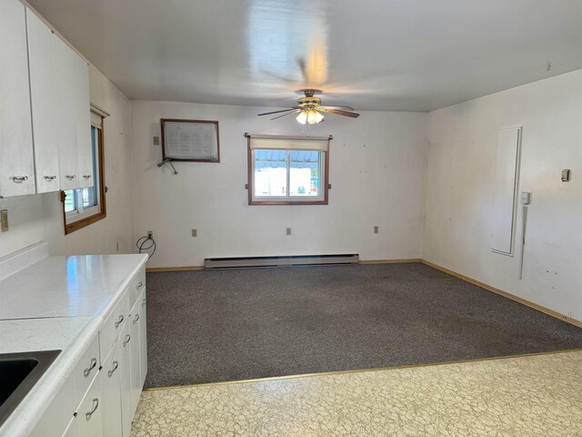 216 NW Cole Ave, Wilbur, WA 99185 - kitchen featuring a baseboard radiator, a ceiling fan, white cabinets, and light countertops