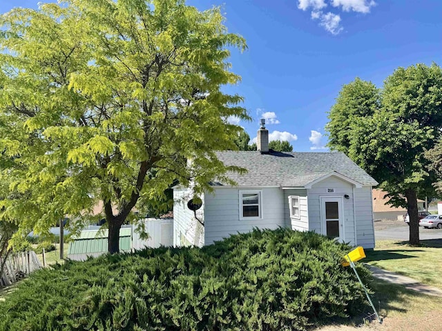 216 NW Cole Ave, Wilbur, WA 99185 - view of home's exterior with a chimney and a shingled roof