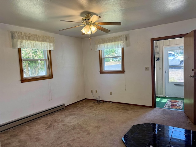 216 NW Cole Ave, Wilbur, WA 99185 - foyer featuring a baseboard radiator, carpet, plenty of natural light, and ceiling fan