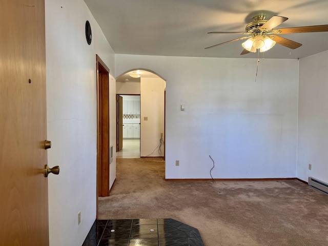 216 NW Cole Ave, Wilbur, WA 99185 - unfurnished room with arched walkways, a ceiling fan, carpet flooring, and baseboards