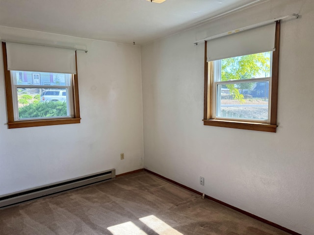 216 NW Cole Ave, Wilbur, WA 99185 - empty room featuring a baseboard radiator, carpet, and baseboards