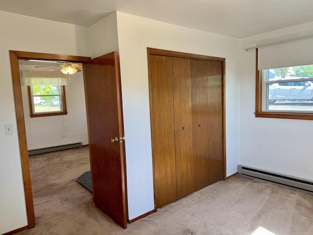 216 NW Cole Ave, Wilbur, WA 99185 - unfurnished bedroom featuring light carpet, a baseboard heating unit, and a closet