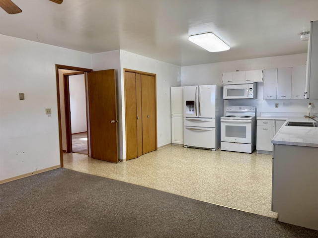 216 NW Cole Ave, Wilbur, WA 99185 - kitchen with white appliances, light countertops, baseboards, ceiling fan, and a sink
