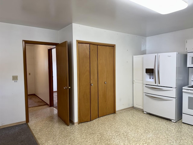 216 NW Cole Ave, Wilbur, WA 99185 - kitchen featuring white appliances, light flooring, and baseboards
