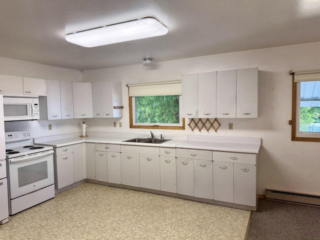 216 NW Cole Ave, Wilbur, WA 99185 - kitchen featuring white appliances, a sink, light countertops, baseboard heating, and light flooring