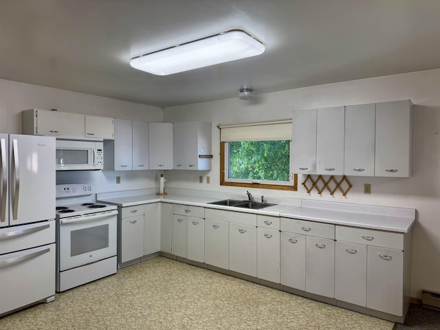 216 NW Cole Ave, Wilbur, WA 99185 - kitchen with white appliances, a sink, light countertops, light floors, and gray cabinetry