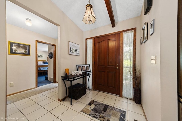 4012 S Terra Verde Dr, Veradale, WA 99037 - entryway featuring beam ceiling, baseboards, light colored carpet, a textured ceiling, and light tile patterned floors