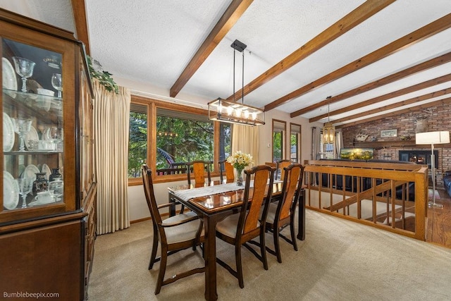 4012 S Terra Verde Dr, Veradale, WA 99037 - dining room featuring plenty of natural light, light carpet, a fireplace, and a textured ceiling