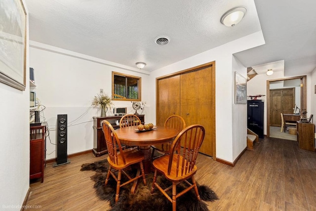 4012 S Terra Verde Dr, Veradale, WA 99037 - dining room with wood finished floors, baseboards, and a textured ceiling