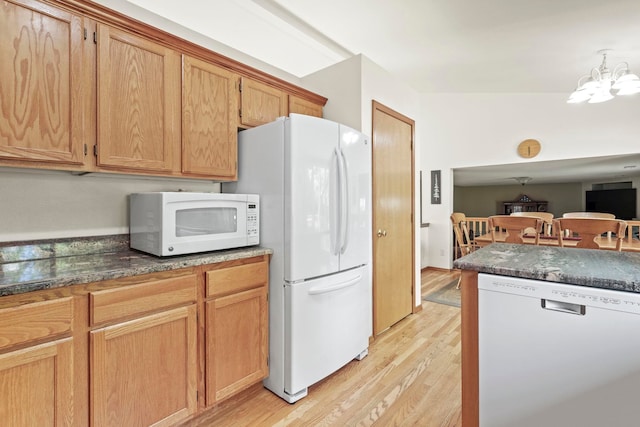8115 E Sommerset Dr, Spokane, WA 99212 - kitchen with white appliances, light wood-type flooring, dark countertops, and a chandelier